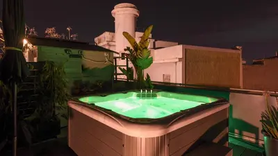 a hot tub on the roof of a building with a lighthouse at Monastiraki CityCenter Sleepbox- Unspoiled Athens Apartments in Athens