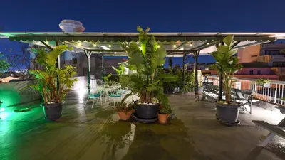 a group of potted plants on a patio at night at Monastiraki CityCenter Sleepbox- Unspoiled Athens Apartments in Athens