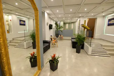 a mirror in a lobby with potted plants at Hotel Byron in Athens
