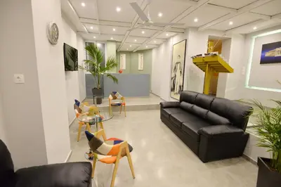 a living room with a couch and a table and chairs at Hotel Byron in Athens