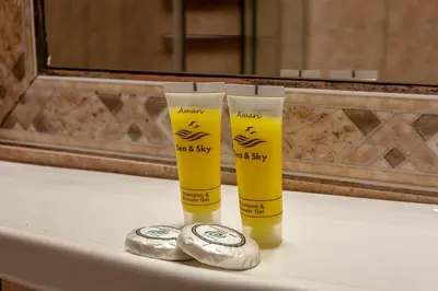 two tall yellow cups sitting on a bathroom counter at Hotel Byron in Athens