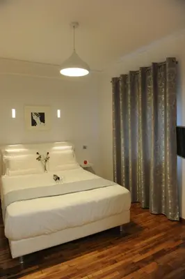 a bedroom with a large white bed and curtains at Modern and Cozy Apartment in the centre of Athens in Athens