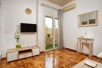 a living room with a flat screen tv on the wall at Modern and Cozy Apartment in the centre of Athens in Athens