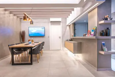 a kitchen and dining room with a table and chairs at Acropolis Stay in Athens