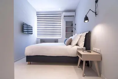 a small bedroom with a bed and a window at Acropolis Stay in Athens