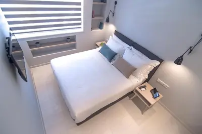 a small bedroom with a bed and a window at Acropolis Stay in Athens