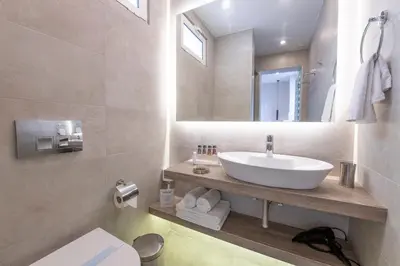 a bathroom with a sink and a mirror at Acropolis Stay in Athens