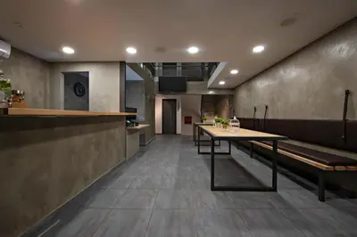 a restaurant with a table and benches in a room at Bedbox Hostel in Athens