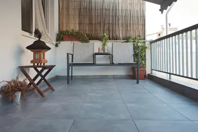 a patio with two chairs and a table on a balcony at Bedbox Hostel in Athens