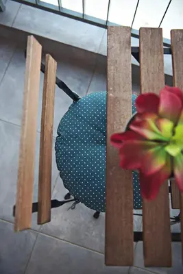 a chair with a flower on the back of it at Bedbox Hostel in Athens