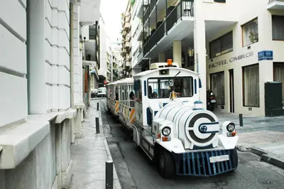 a small train is parked on a city street at Omiros Hotel in Athens