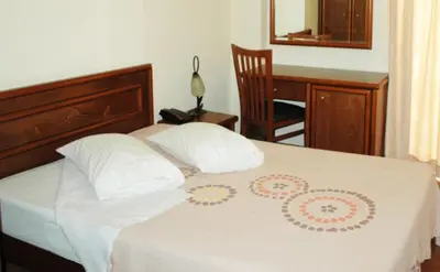 a bedroom with a bed with two pillows on it at Omiros Hotel in Athens