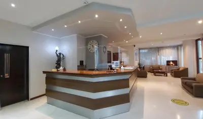 a lobby with a bar and a living room at Omiros Hotel in Athens