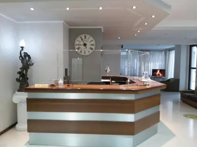 a large kitchen with a clock on the wall at Omiros Hotel in Athens