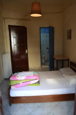 a bedroom with a bed with towels on it at Argo Hotel in Athens