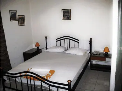 a bedroom with a large bed with two pillows at Argo Hotel in Athens