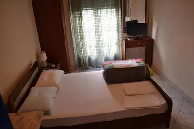 a small bedroom with a bed with a window at Argo Hotel in Athens