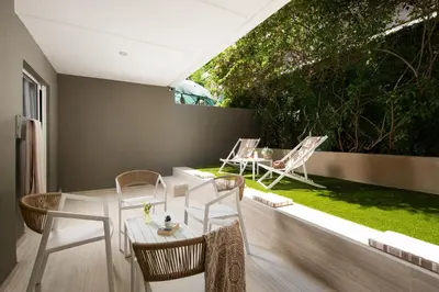a patio with a table and chairs on a balcony at Athenian Riviera Hotel& Suites in Athens