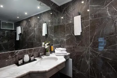 a bathroom with a sink and a mirror at Athenian Riviera Hotel& Suites in Athens