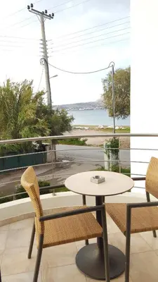 a table and chairs on a balcony with a view of a street at Sea Sight Boutique Hotel in Porto Rafti