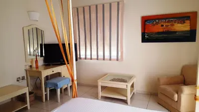 a bedroom with a bed and a desk and a chair at Sea Sight Boutique Hotel in Porto Rafti