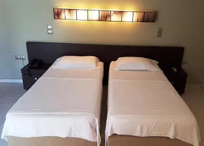 two beds sitting next to each other in a room at Sea Sight Boutique Hotel in Porto Rafti