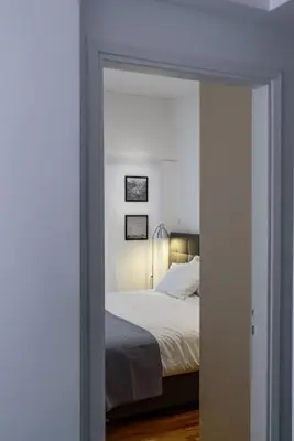 a bedroom with a bed and a mirror at Modern design apartment near Acropolis in Athens