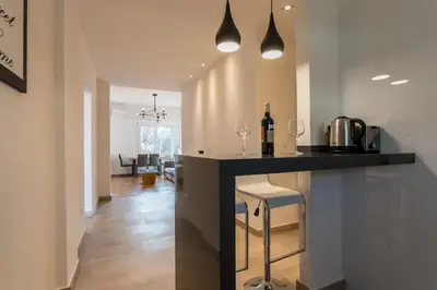 a kitchen with a counter with wine glasses on it at Pagrati 2bdr Flat in Athens