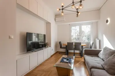 a living room with a couch and a tv at Pagrati 2bdr Flat in Athens