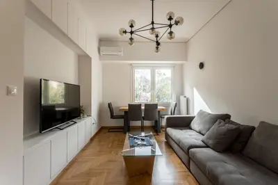 a living room with a couch and a table at Pagrati 2bdr Flat in Athens