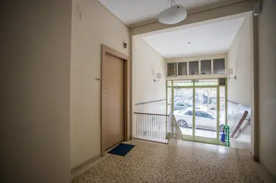 an empty hallway with a door and a car outside at Pagrati 2bdr Flat in Athens