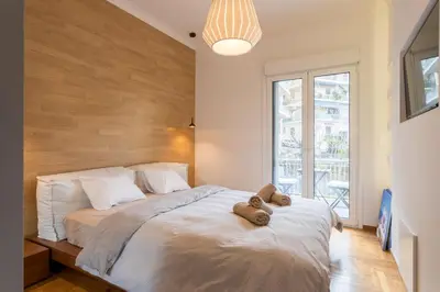 a bedroom with a bed with two teddy bears on it at Pagrati 2bdr Flat in Athens