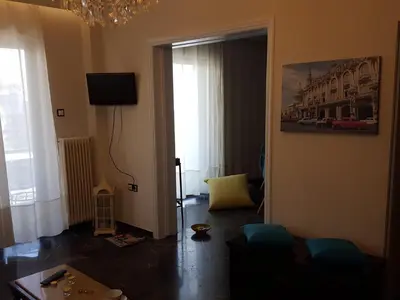 a living room with a door open to a living room at Superb Athenian Nest in Athens