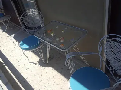a table and chairs with a glass top at Superb Athenian Nest in Athens