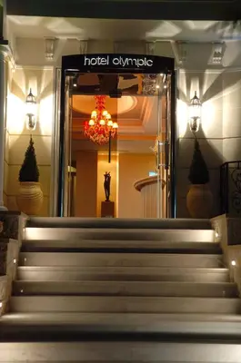 a set of stairs in a building with a chandelier at Olympic Fashion Hotels in Athens