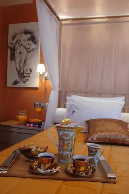 a tray with two cups and a vase on a table at Olympic Fashion Hotels in Athens