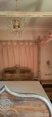 a bedroom with a bed with a chandelier at Olympic Fashion Hotels in Athens