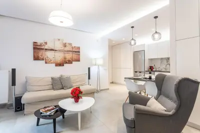 a living room with a couch and a table at Stadium 1bdr HiEnd quiet Flat Top Location in Athens