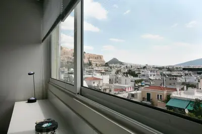a window with a view of a city at Mind-blowing Acropolis View Apt in Athens