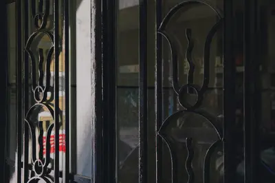 a view of a window through a wrought iron fence at Luxury apartment central in Athens