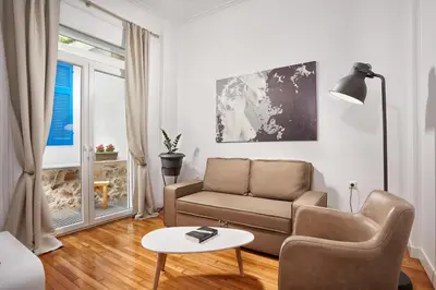 a living room with a couch and a table at Luxury apartment central in Athens