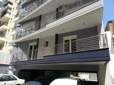 a building with balconies and cars parked in front of it at Super 36sqm Junior Suite in luxurious picturesque area in Piraeus