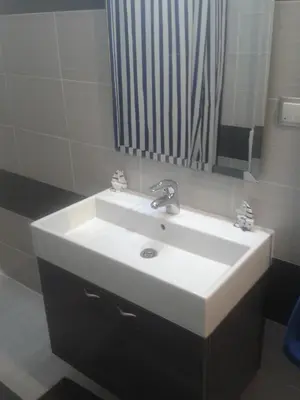 a bathroom with a white sink and a mirror at Super 36sqm Junior Suite in luxurious picturesque area in Piraeus