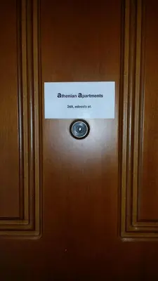 a sign on a door with a sign on it at Athenian apartment with garden, near metro station Chalandri Nu 3 in Athens