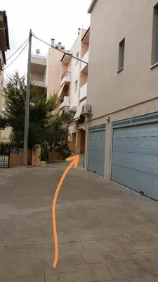 an empty parking lot with two garage doors at Athenian apartment with garden, near metro station Chalandri Nu 3 in Athens