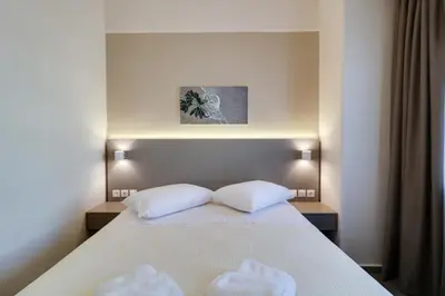 a bedroom with a bed with two white pillows at Athens Comfort in Athens
