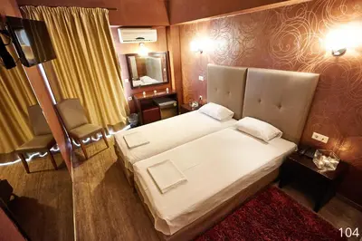 a hotel room with a large bed and a mirror at Atlantic Hotel in Athens