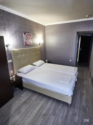 a bedroom with a large bed with white sheets at Atlantic Hotel in Athens