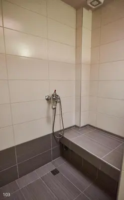 a shower in a bathroom with a tile floor at Atlantic Hotel in Athens