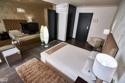 a large living room with a couch and a television at Atlantic Hotel in Athens